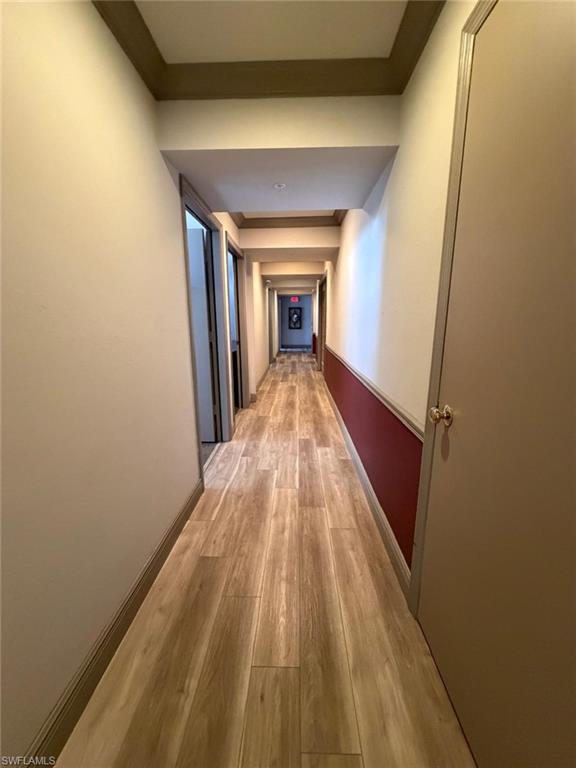 Hall featuring light wood-style floors and baseboards