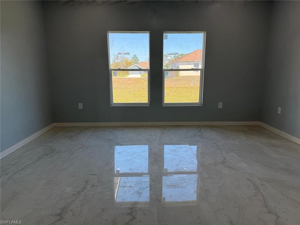 Unfurnished room with baseboards