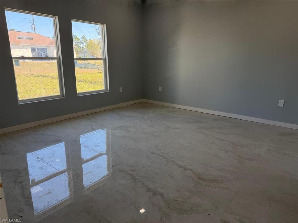 Unfurnished room with baseboards