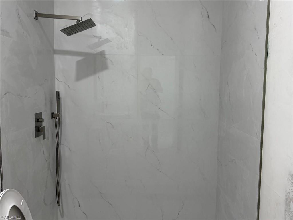 Full bathroom featuring a marble finish shower