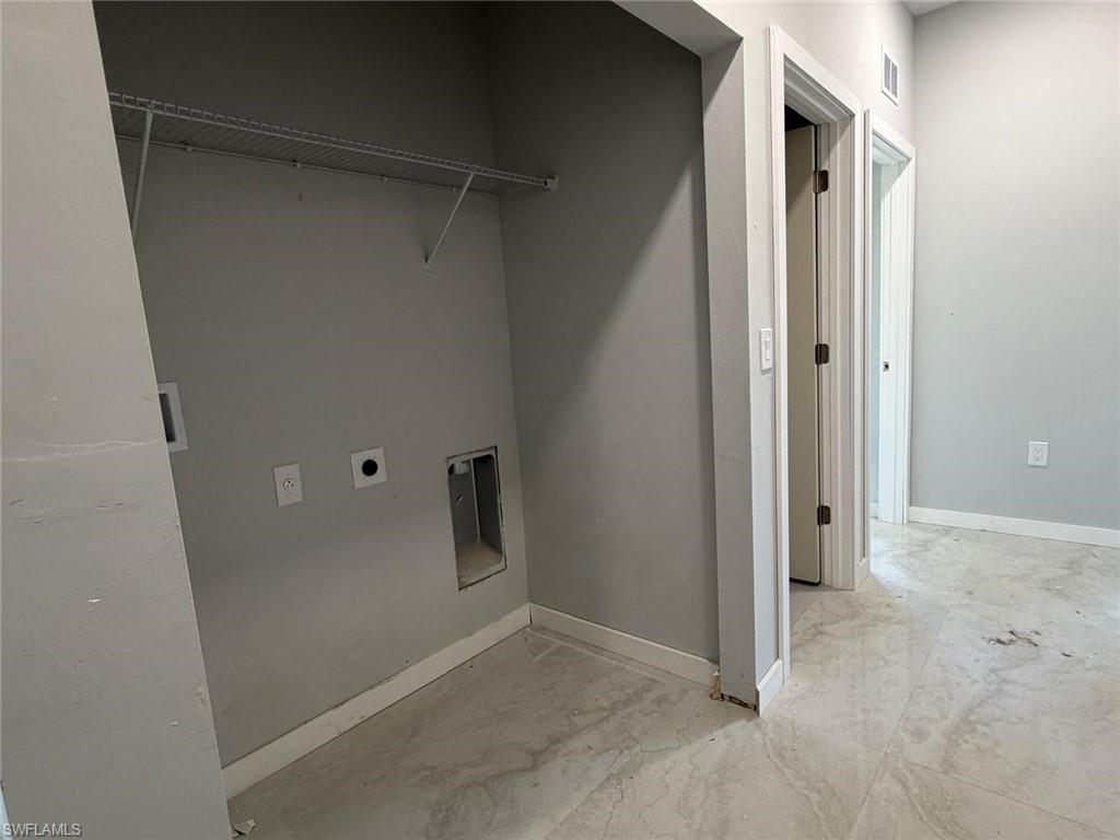 Laundry room with baseboards and hookup for an electric dryer