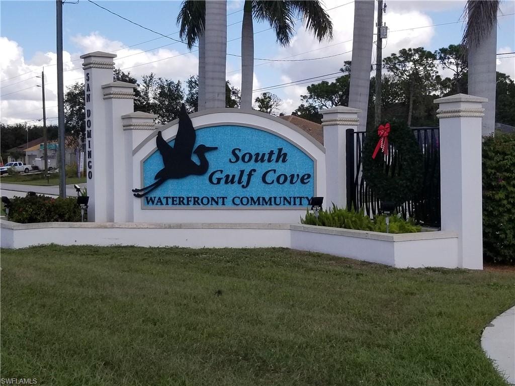 Community / neighborhood sign featuring a yard