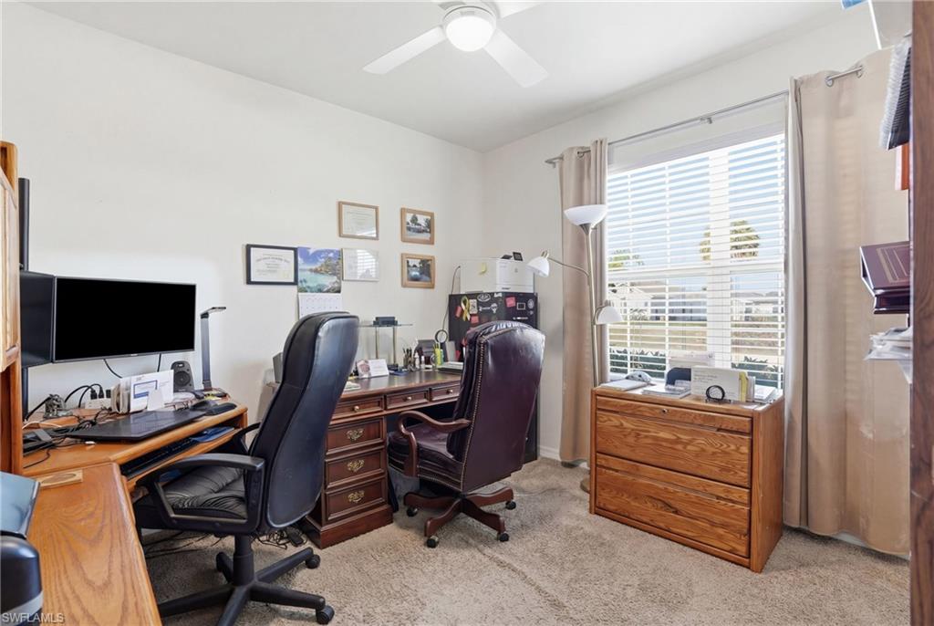 Office space featuring light colored carpet and ceiling fan