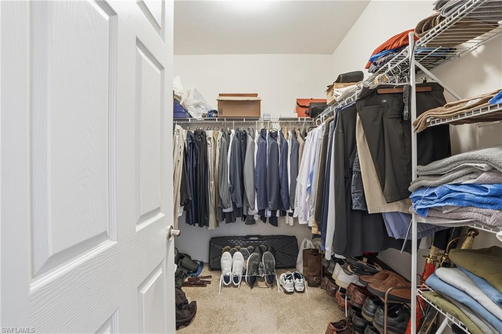 Walk in closet featuring light carpet