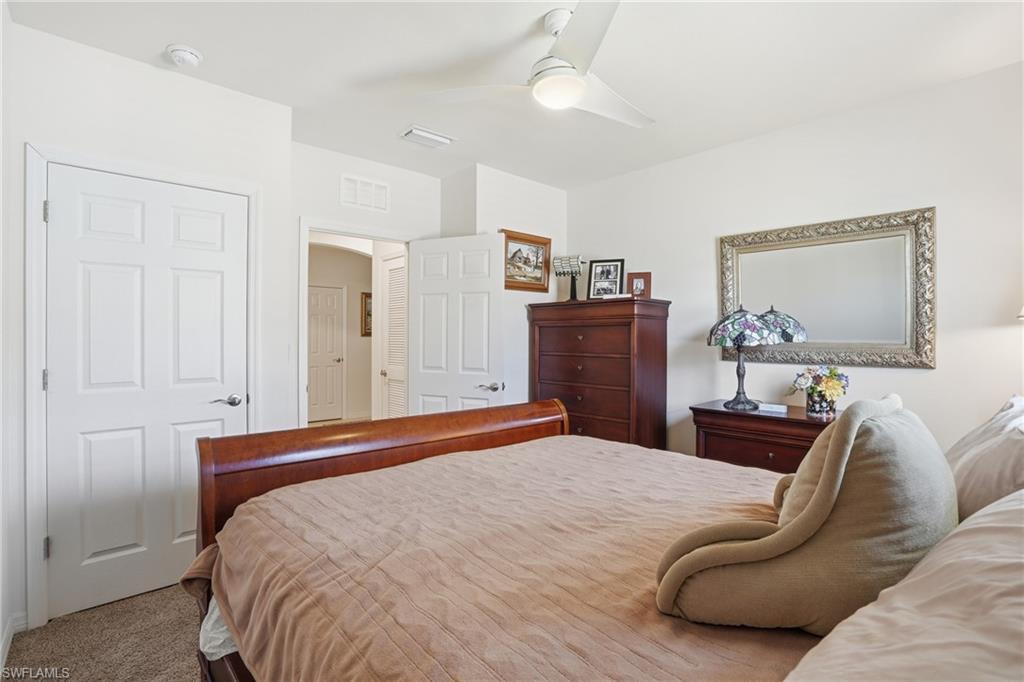 Carpeted bedroom with ceiling fan