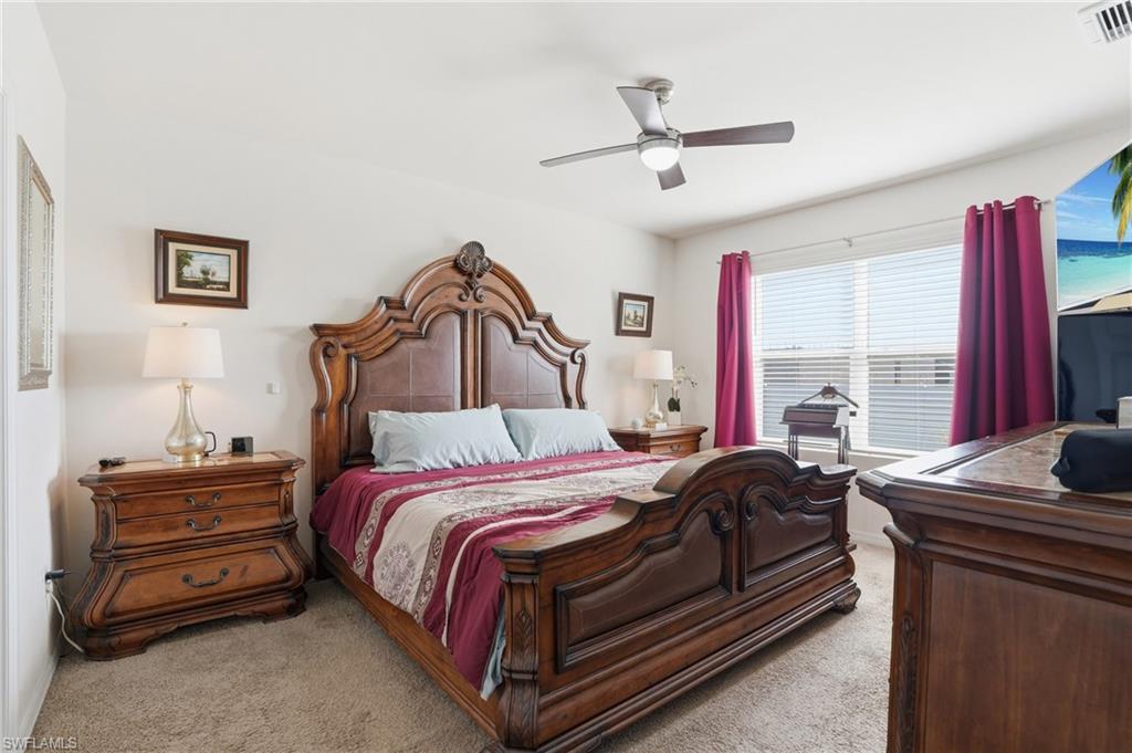 Bedroom featuring ceiling fan and light carpet