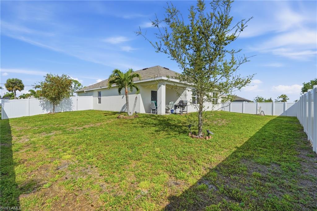 Back of property with a patio area, a fenced backyard, and stucco siding