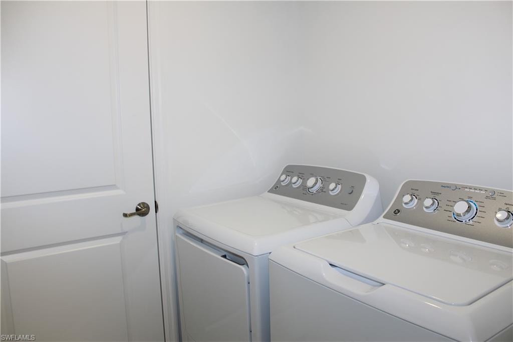 Guest bath with vanity, toilet, baseboards, visible vents, and washtub / shower combination