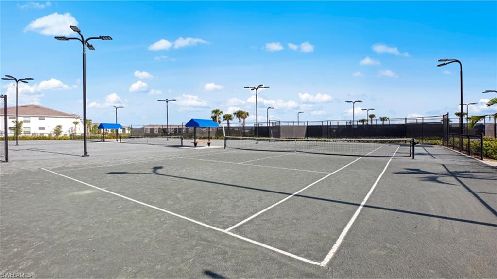 View of tennis court featuring fence