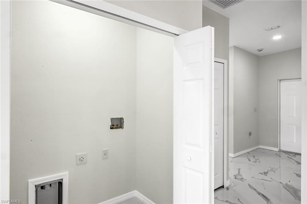 Laundry area with light marble finish floors, hookup for a washing machine, hookup for an electric dryer, and recessed lighting