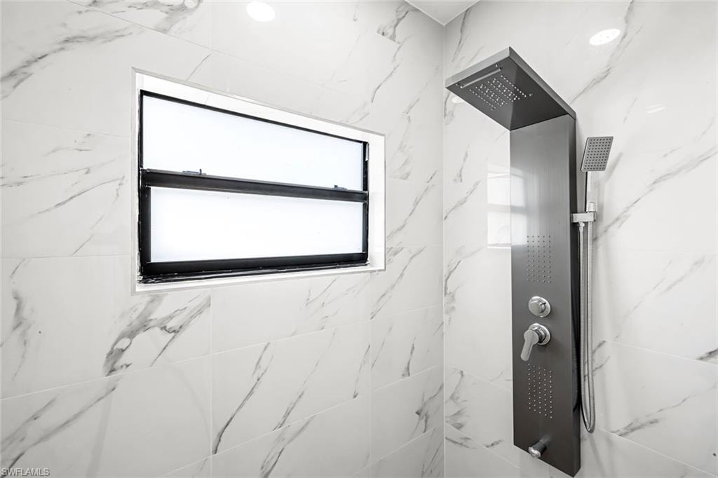Bathroom with a marble finish shower