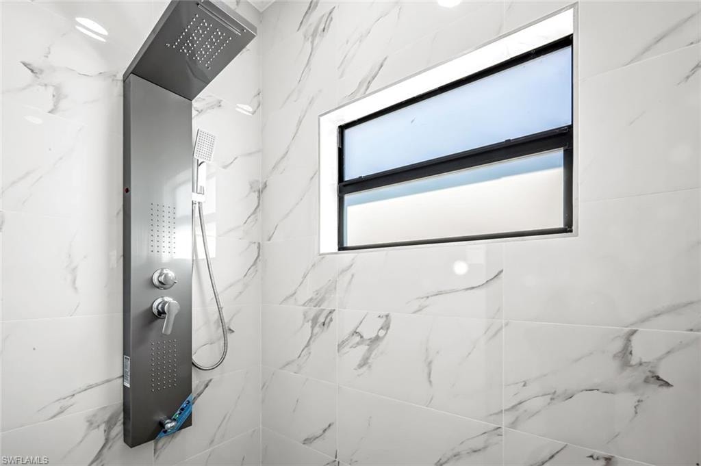 Full bathroom featuring a marble finish shower