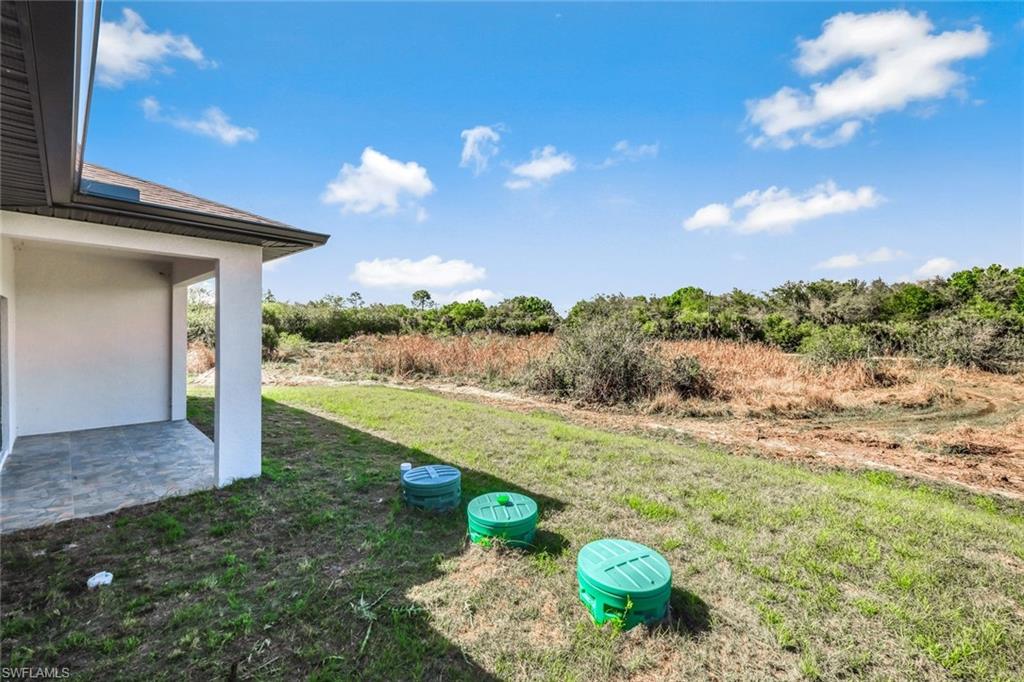 View of green lawn featuring a patio area