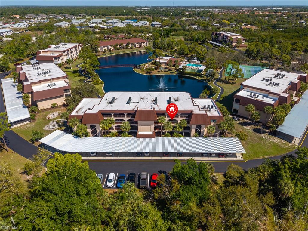 Drone / aerial view of apartment complex and a large body of water