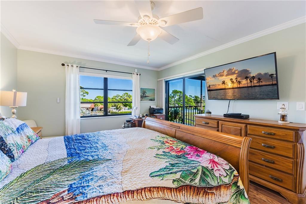 Bedroom featuring crown molding, a ceiling fan, wood finished floors, and access to exterior
