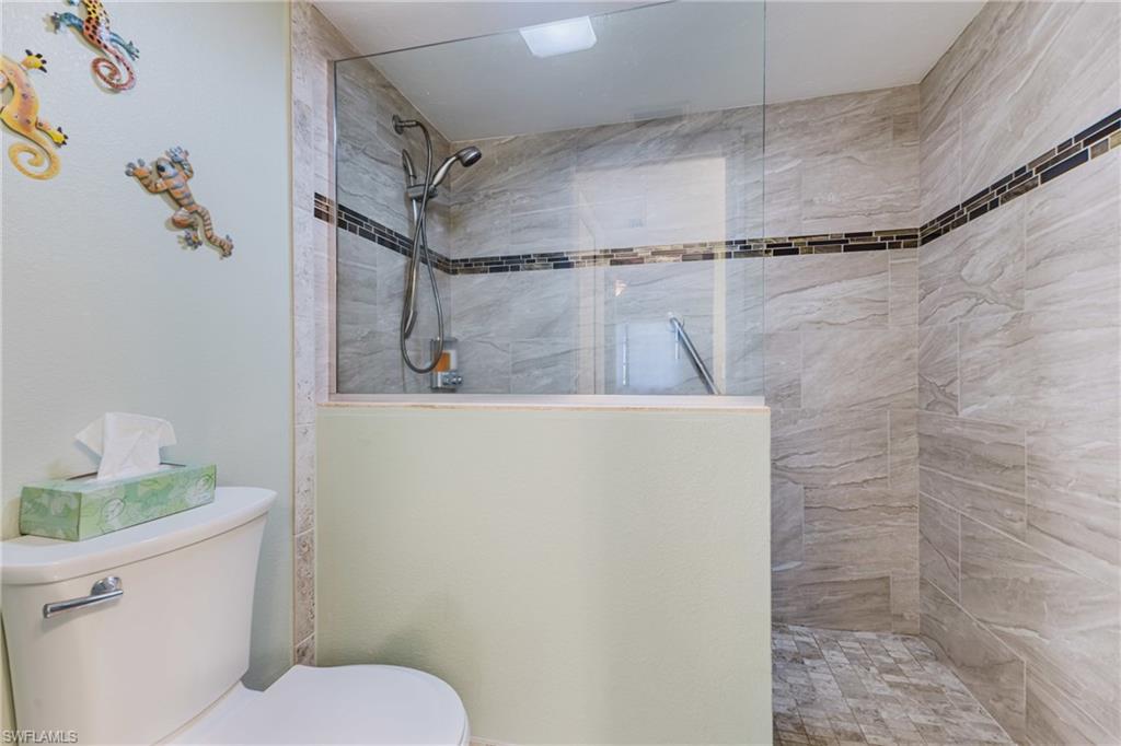 Bathroom featuring walk in shower and toilet