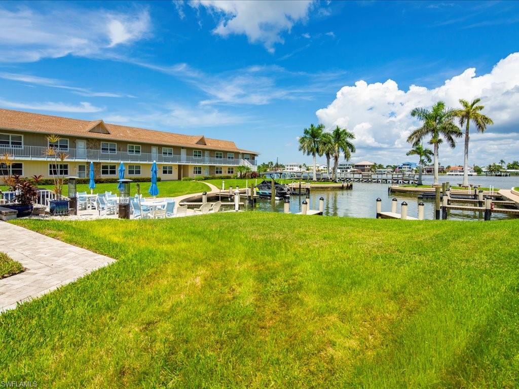 Dock featuring a water view and a yard