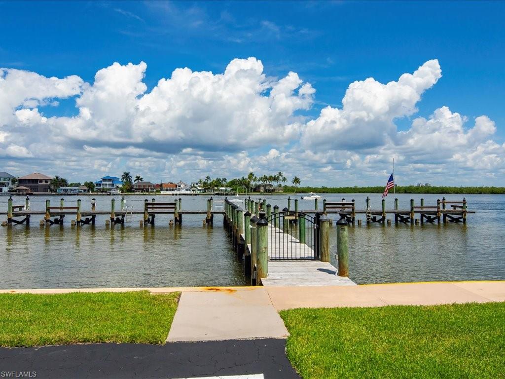 Dock with a water view and a yard