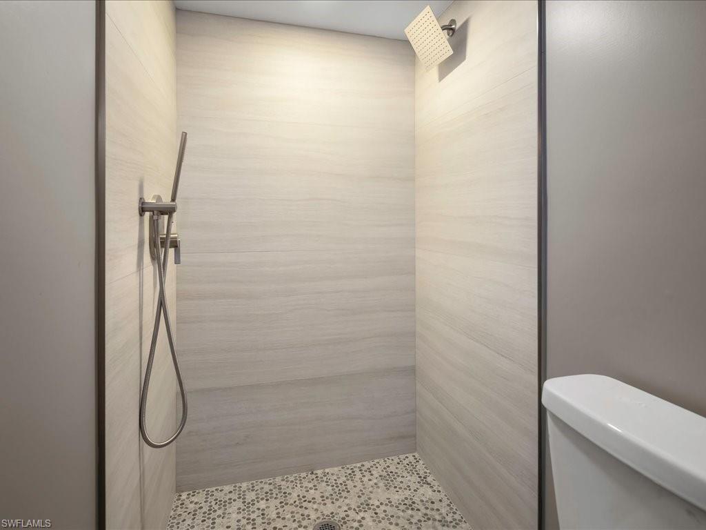 Bathroom featuring toilet and a tile shower