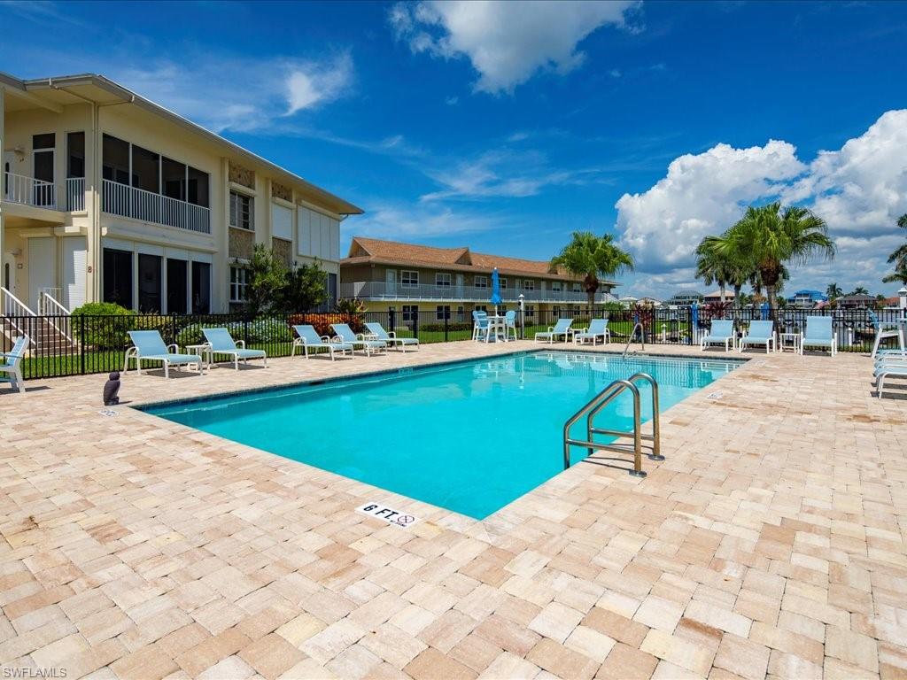 Community pool with a patio