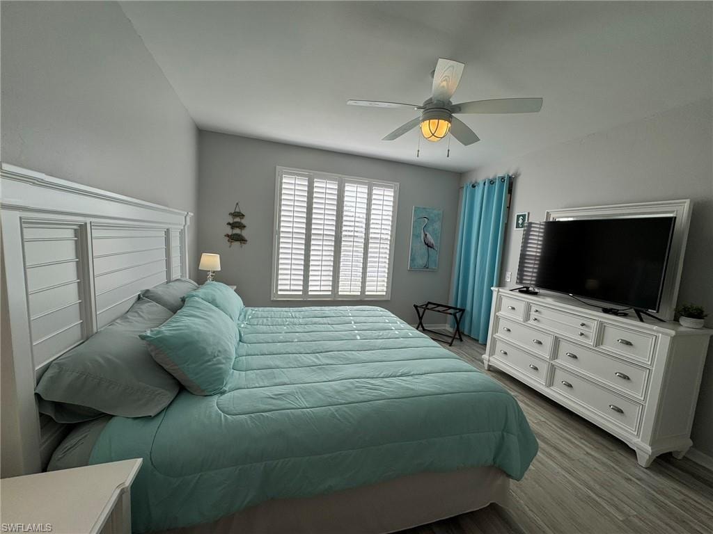 Bedroom with light hardwood / wood-style floors and ceiling fan