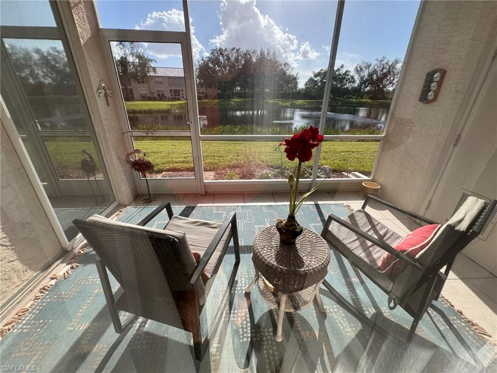 Sunroom featuring a water view