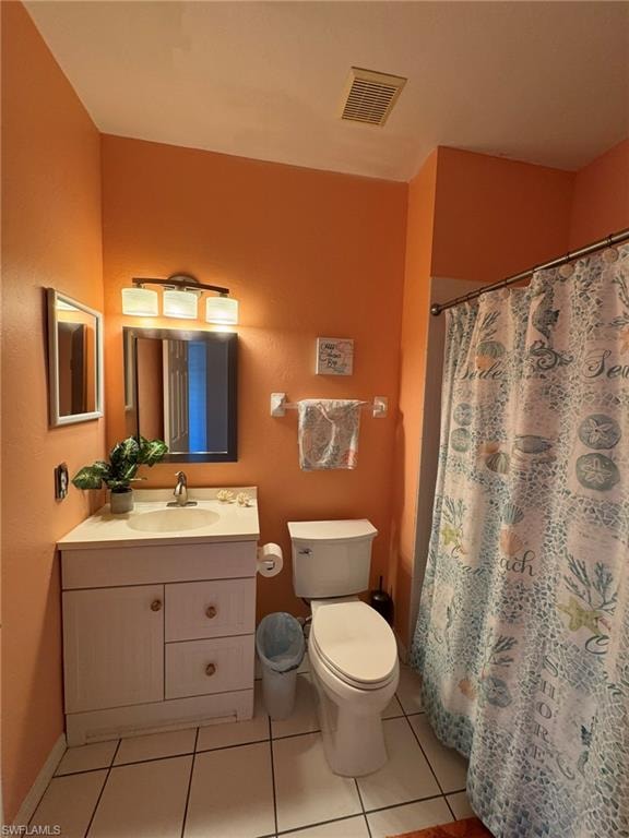 Bathroom with vanity, walk in shower, toilet, and tile patterned flooring