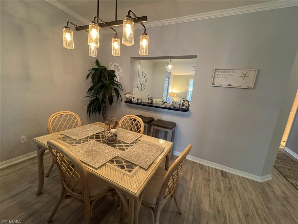 Dining space featuring ornamental molding and hardwood / wood-style floors