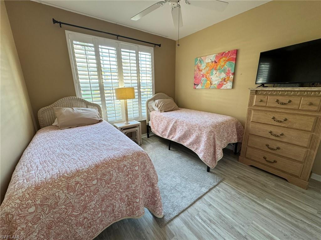 Bedroom with light hardwood / wood-style floors and ceiling fan