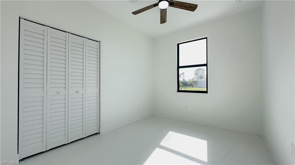 Unfurnished bedroom featuring a closet and ceiling fan
