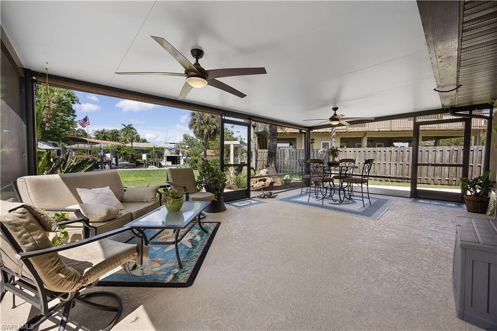 Sunroom / solarium with outdoor dining area, a patio area, ceiling fan, and healthy amount of natural light