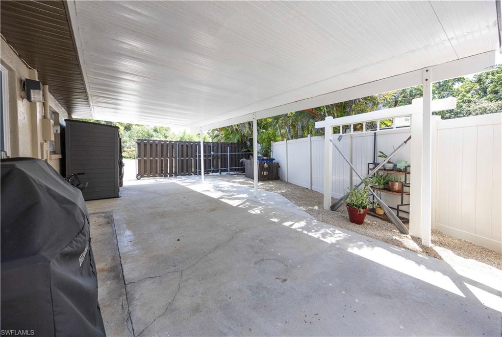 Fenced backyard featuring grilling area and a patio area