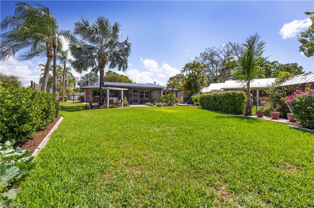 View of green lawn featuring a patio area