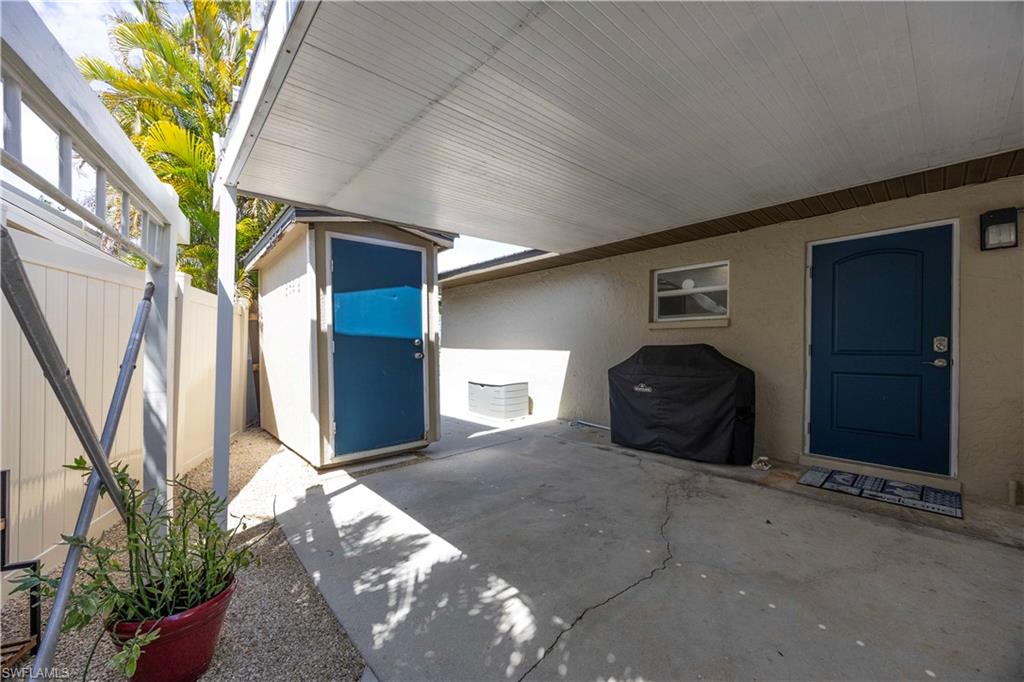 Fenced backyard with a storage shed and a patio