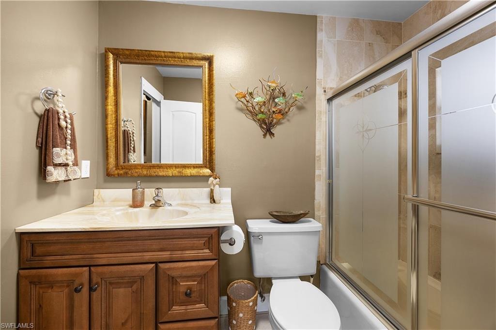 Full bathroom featuring vanity and enclosed tub / shower combo