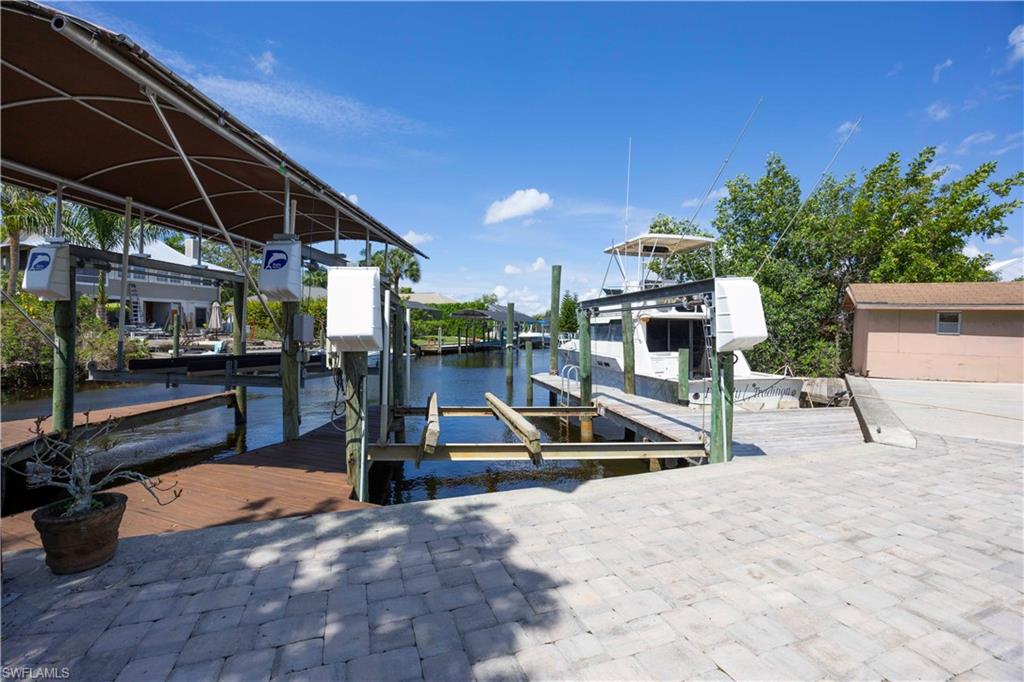 Dock area with boat lift and a water view