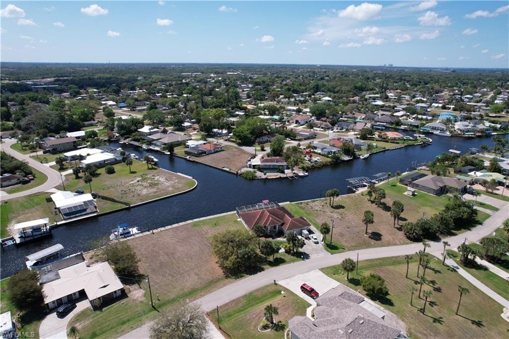 Aerial view of property's location featuring nearby suburban area and a nearby body of water