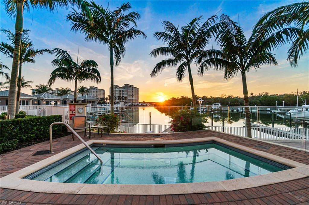 Twilight View of swimming pool featuring a patio, spa and lounging areas