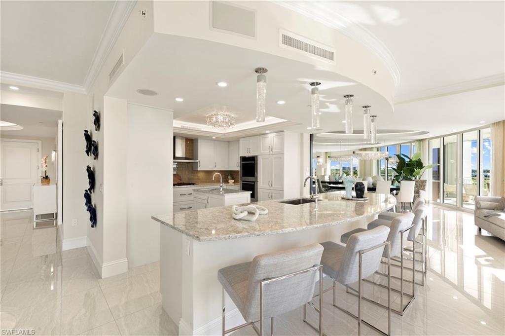 Panorama View of Kitchen, Casual Bar, Living Room and Dining Room from Breakfast Area