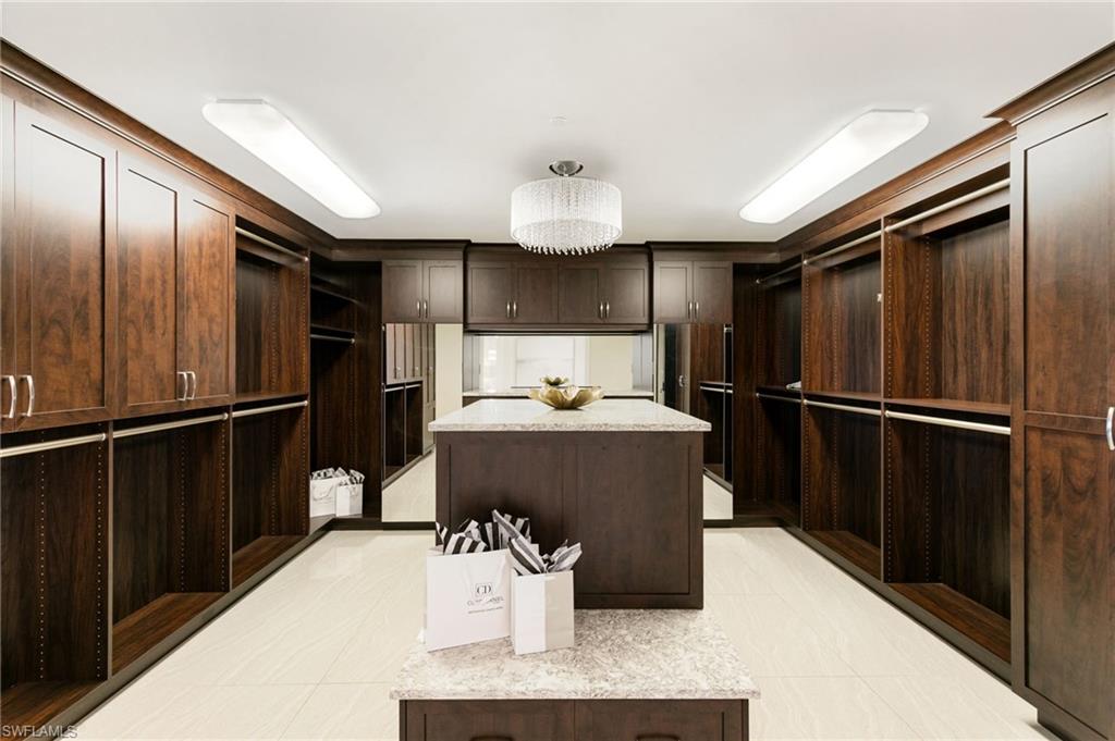 Spacious Walk in closet with a chandelier and plenty of Storage