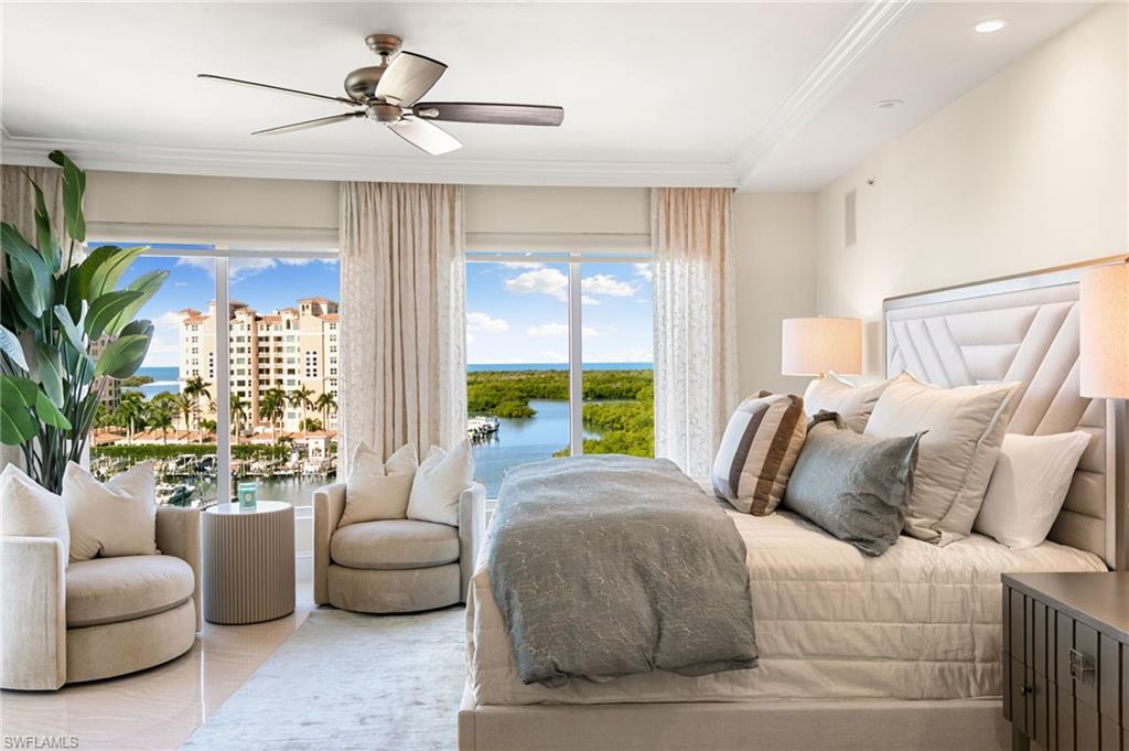Bedroom with a water view, ceiling fan, and ornamental molding