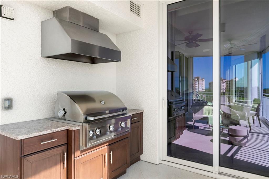 Balcony with ceiling fan, grilling area (no longer permitted, this one is grand-fathered in) and exterior kitchen