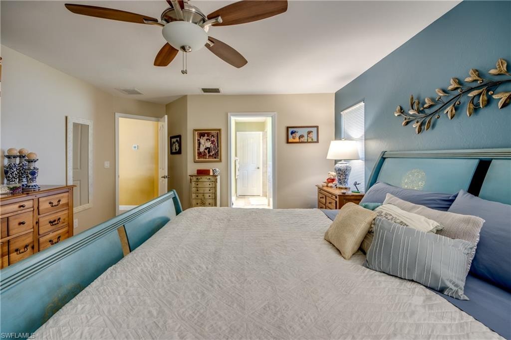 Bedroom featuring ceiling fan and connected bathroom