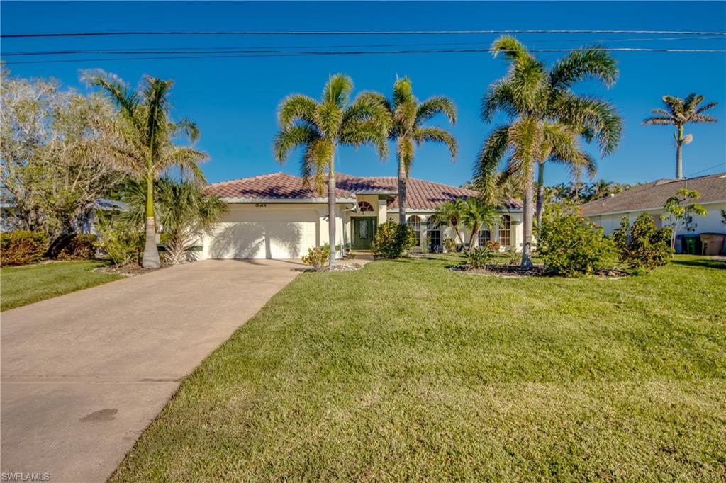 View of front of home featuring a garage and a front lawn