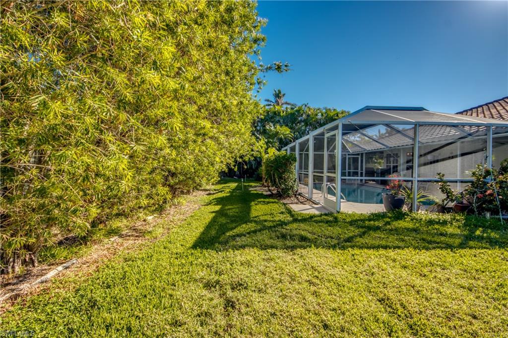 View of yard with a lanai