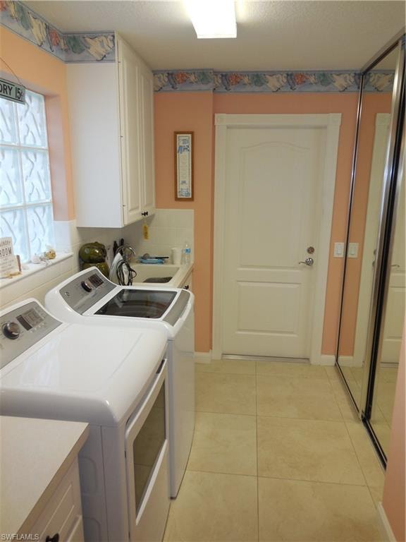 Laundry room with washer and dryer and cabinets