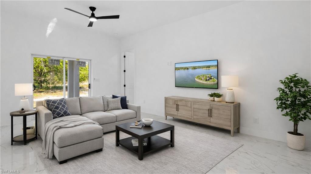 Virtually Staged Living room featuring ceiling fan and marble finish flooring