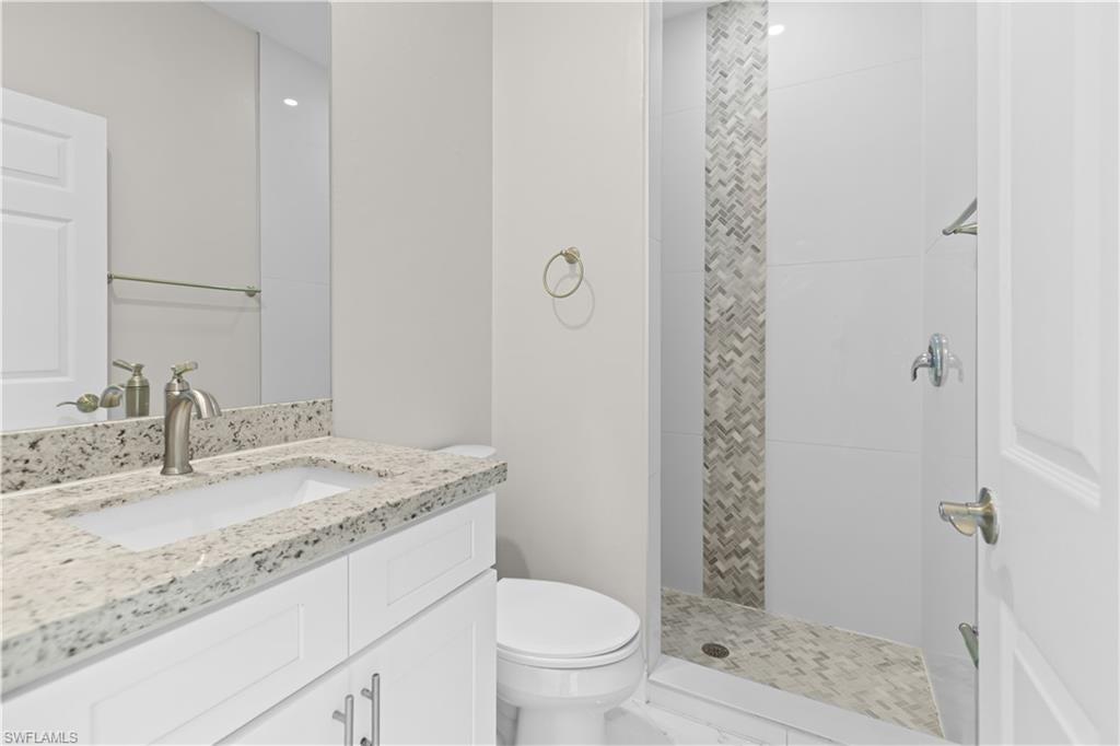 Full bath with vanity and tiled shower