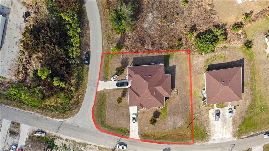 Aerial view of property and surrounding area featuring property parcel outlined