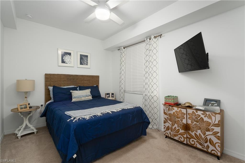 Bedroom with carpet flooring, ceiling fan, and baseboards